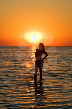 Royalty Free Photo of a Woman in the Water at Sunset