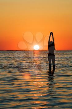 Royalty Free Photo of a Woman in the Water at Sunset