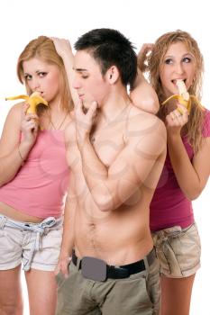 Royalty Free Photo of a Boy With Two Girls Eating Bananas