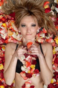 Royalty Free Photo of a Woman Lying in Flower Petals