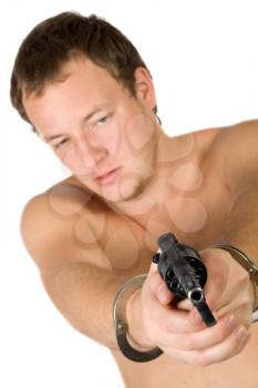 Royalty Free Photo of a Shirtless Man in Cuffs Holding a Gun