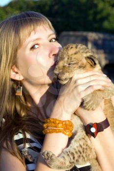 Royalty Free Photo of a Woman Holding a Lion Cub