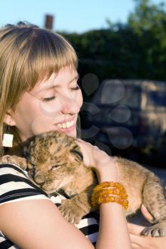 Royalty Free Photo of a Woman Holding a Lion Club