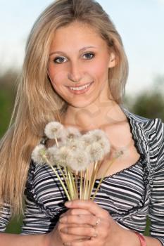 Royalty Free Photo of a Woman Holding Dandelions