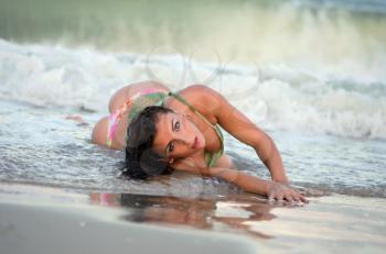 Sexy young woman lying on the beach