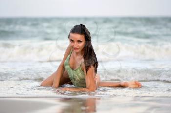 Sexy nice young woman lying on the beach