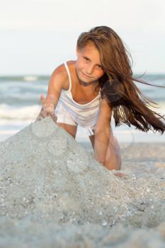 Pretty little girl playing on the beach