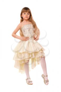 Pretty little girl in a beige dress. Isolated