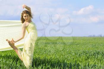 Beautiful flexible young woman wrapped in yellow cloth