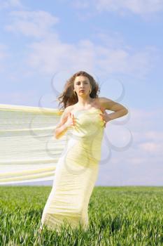 Young attractive woman wrapped in yellow cloth