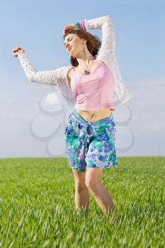 Attractive young woman in a green field