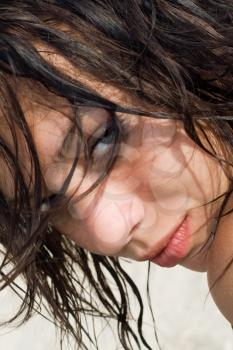 Pretty wet brunette on the beach. Closeup