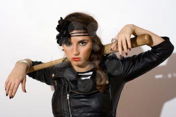Serious young woman with a bat in their hands