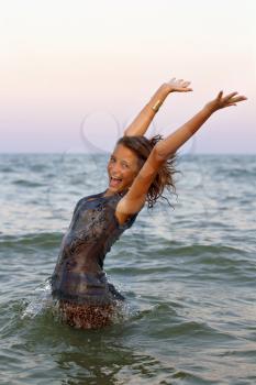 Happy wet teen girl having fun in the sea