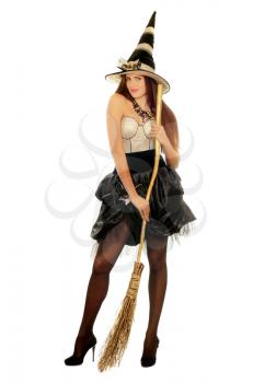 Young woman with a besom wearing costume witch