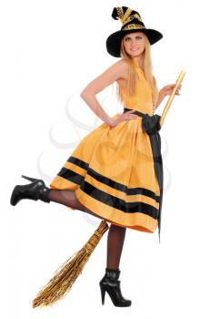 Playful young woman with a besom wearing costume witch. Isolated