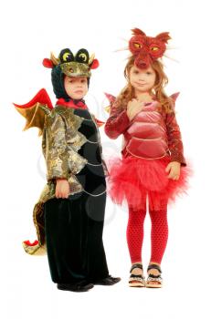 Two small children dressed as dragons. Isolated