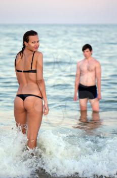 Young couple in the sea. Focus on a girl