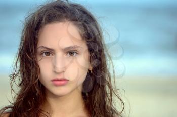 Portrait of a serious teen girl on the beach