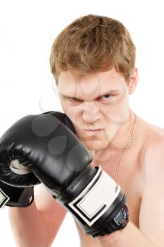 Angry young man in boxing gloves. Isolated