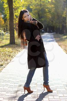 Young woman standing on road in the park