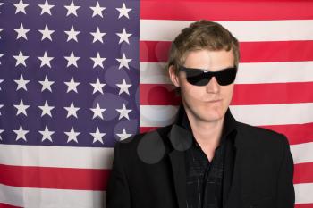Man in sunglasses on a background of the American flag