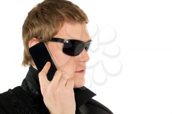 Young man in black sunglasses with mobile phone. Isolated
