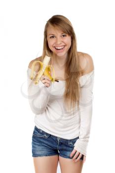 Smiling woman in blue jeans shorts holding banana. Isolated on white