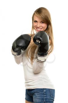 Pretty smiling blond woman posing in boxing gloves. Isolated