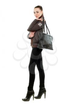 Pretty brunette with a bag wearing black pants and shoes. Isolated on white 