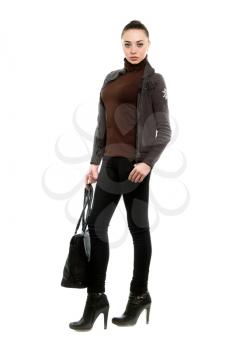 Attractive young brunette dressed in casual style with a bag. Isolated on white   