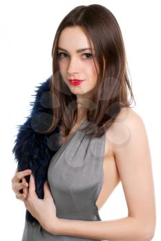 Portrait of pretty brunette posing with fur. Isolated on white