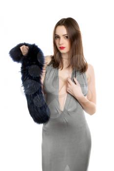 Pretty brunette wearing elegant grey dress with fur. Isolated on white