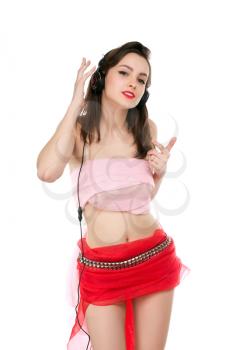 Pretty young woman dancing and listening to music. Isolated on white