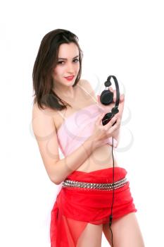 Charming young brunette posing with headphones. Isolated on white