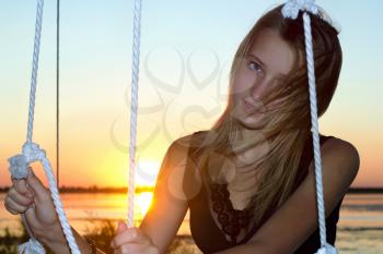 Portrait of the pretty teen girl at sunset