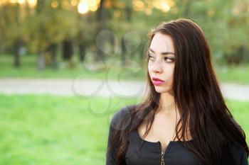 Portrait of pretty young brunette posing outdoor