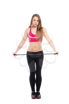 Young slim blonde in black leggings posing with expander. Isolated on white