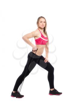 Pretty woman doing exercises with expander. Isolated on white