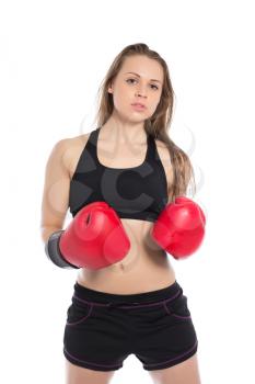 Portrait of young woman posing in big red boxing gloves. Isolated on white
