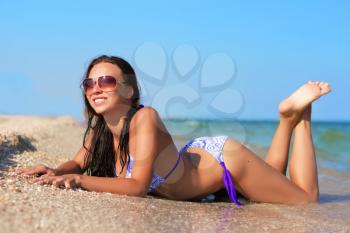 Pretty joyful woman posing on the beach