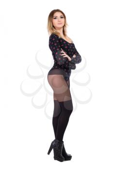 Alluring blond woman posing in black tights and shoes. Isolated on white