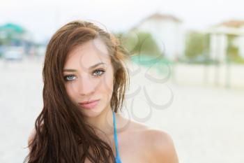 Portrait of young woman with plump lips posing outdoors