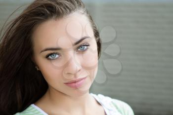 Close-up of pretty caucasian lady with big grey eyes