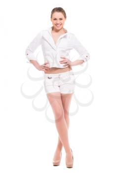 Cheerful young blond woman posing in white shirt and shorts. Isolated on white