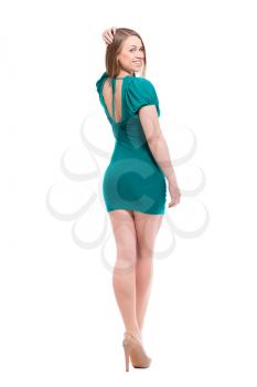 Young blond woman posing in turquoise dress. Isolated on white