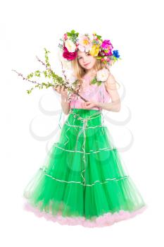 Attractive little girl posing with flowering branches. Isolated on white