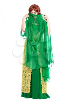 Enigmatic young woman wearing luxury green dress. Isolated on white