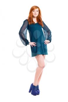 Young pretty redhead woman posing in turquoise dress. Isolated on white
