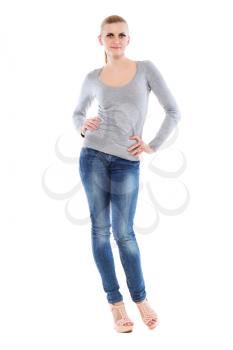 Pretty young blonde posing in blue jeans and grey blouse. Isolated on white